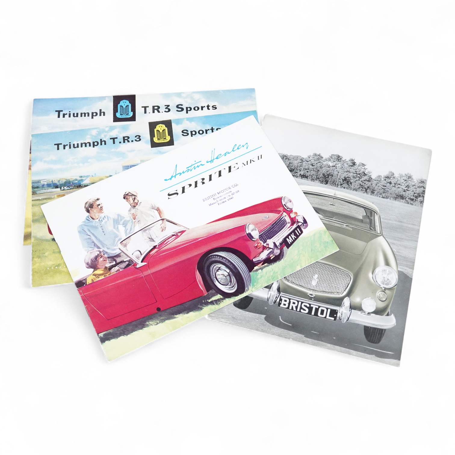 Four 1950s and 1960s motor car manufacturer’s brochures; the Bristol, the Austin Healey Sprite Mk.II (produced 1961-64), and two Triumph T.R.3 Sports (produced 1955-1962)